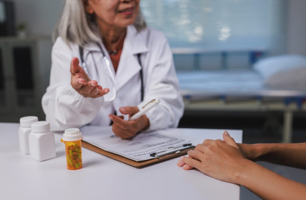 Doctor explaining medication and health information to a patient during a medical consultation